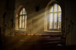 Sun shining through a church stained glass window